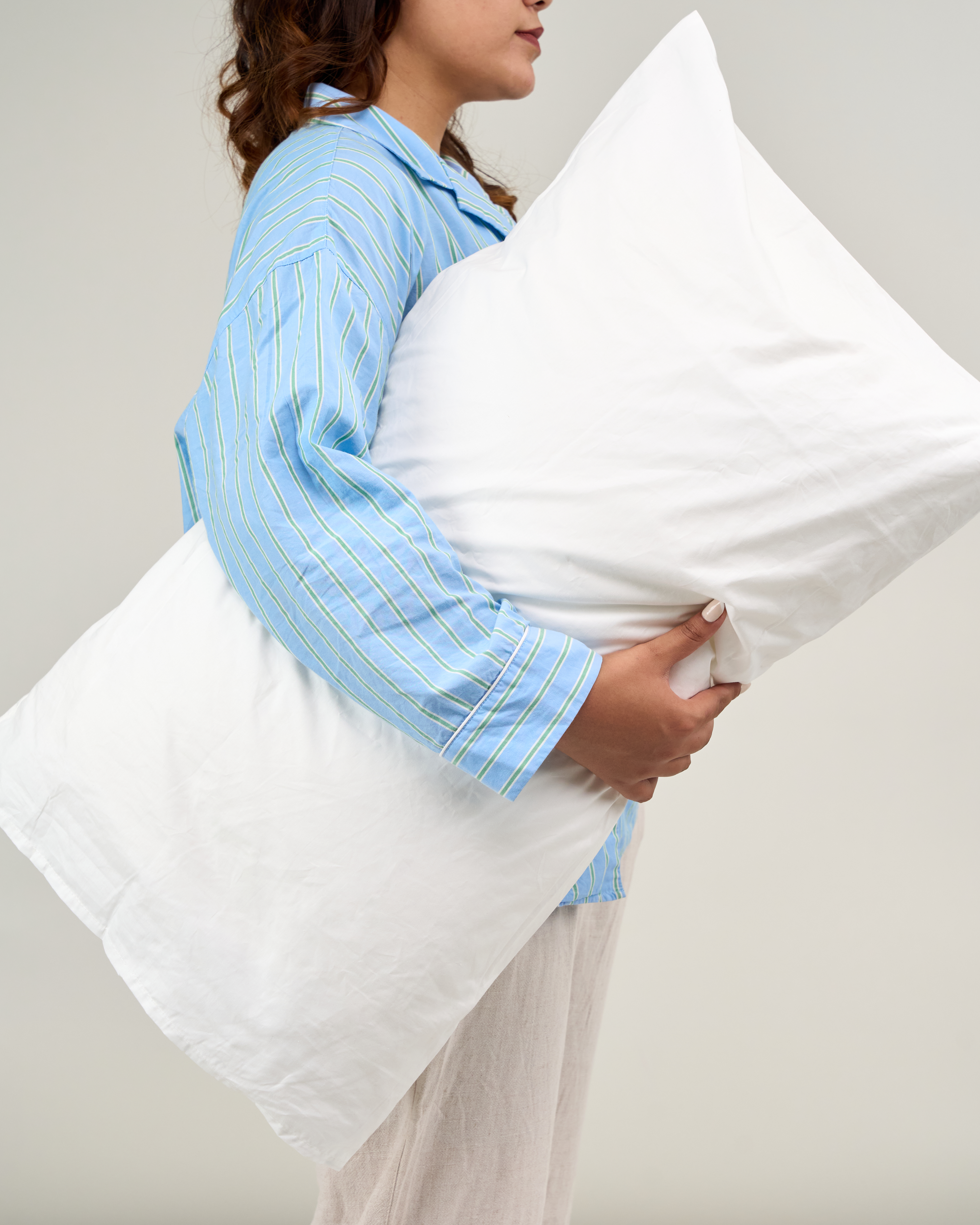 The warmth of Home Kraft — a woman holding a soft pillow